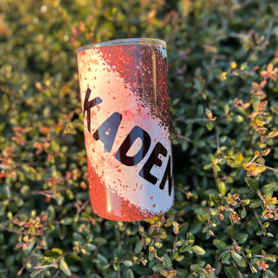 A 14oz fatty stainless steel tumbler with red stars, sparkles, and cheetah prints.  This tumbler includes a silicone bottom, leakproof top, metal straw and straw cleaner. Front view with a customizable option.