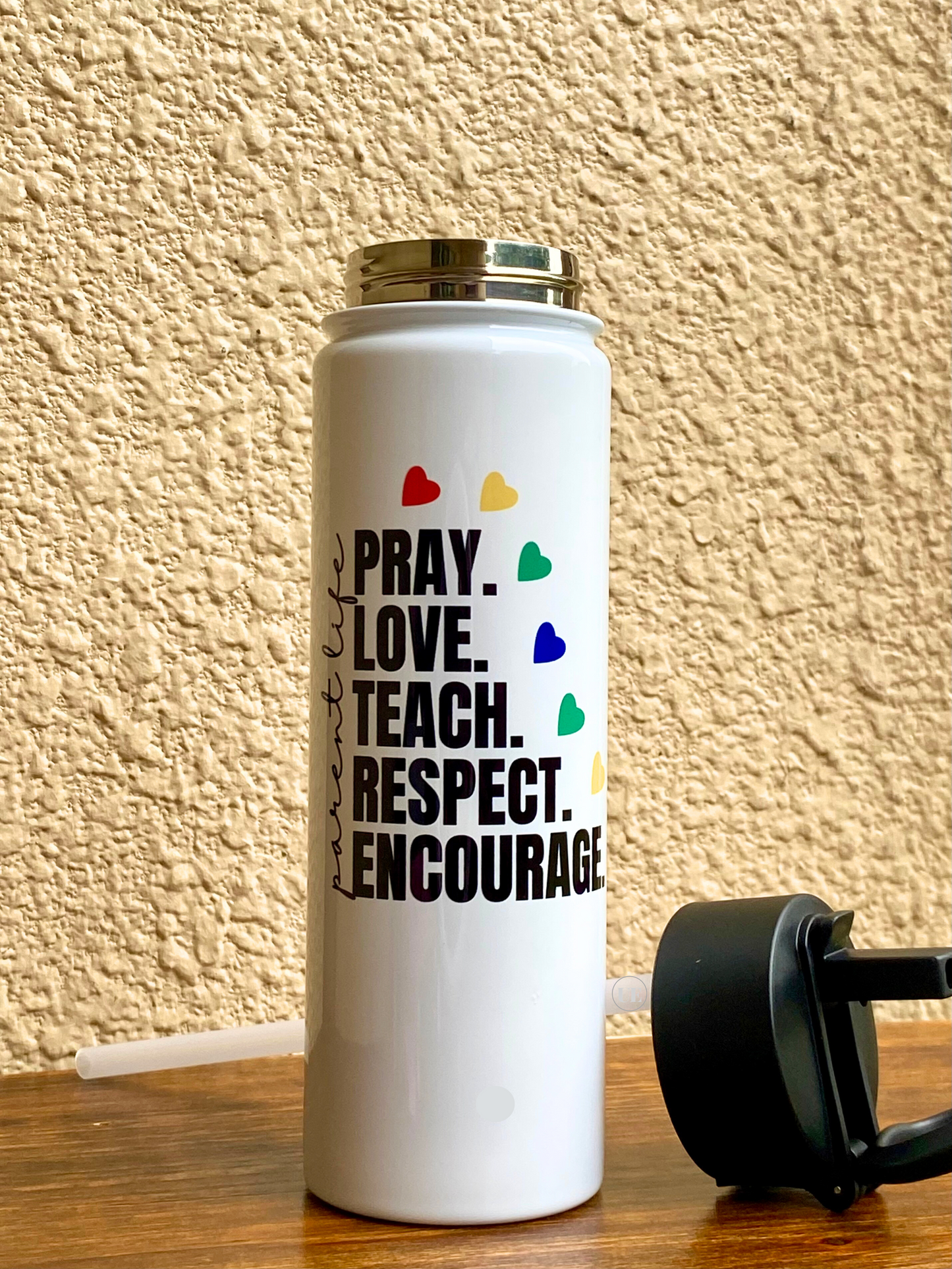 A 22oz stainless steel water bottle to celebrate a parent’s love for their children displaying the portable, sippy-up lid and internal straw.