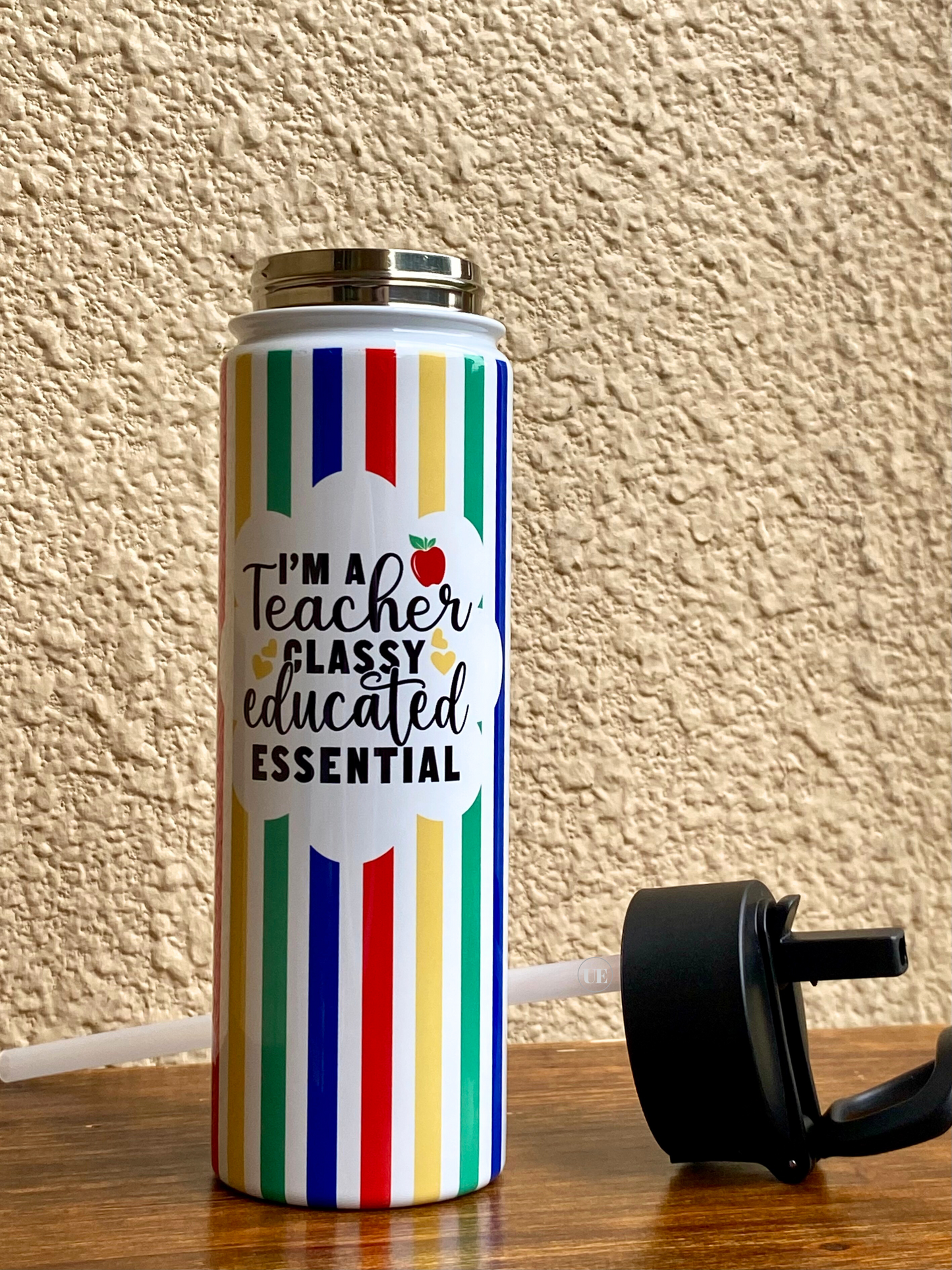 A 22oz stainless steel water bottle to celebrate teachers displaying the portable, sippy-up lid and internal straw.